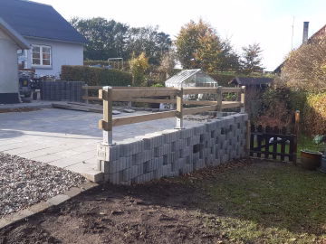 Opbygning af støttemur med armerede plantesten omkring indkørsel nær Viborg